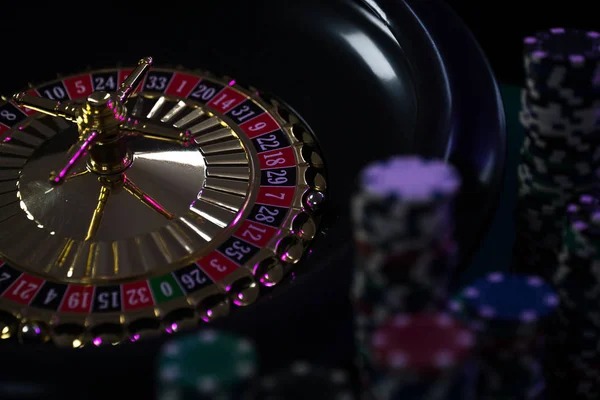 Roulette wheel spinning in live studio with dealer and multiple betting positions